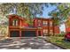 Spacious two-story red home with a garage and well-kept landscaping at 167 Villa Di Este Ter Ter # 213, Lake Mary, FL 32746