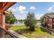 Scenic lake view from a balcony with lush landscaping at 167 Villa Di Este Ter Ter # 213, Lake Mary, FL 32746