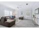 Bright living room with a plush sectional, soft rug, and lots of natural light at 167 Villa Di Este Ter Ter # 213, Lake Mary, FL 32746