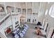 Expansive lobby featuring high ceilings, upper-level balconies, cozy seating, and a fireplace at 167 Villa Di Este Ter Ter # 213, Lake Mary, FL 32746