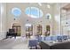Bright lobby area with soaring ceilings, large arched windows, a piano, and ample seating at 167 Villa Di Este Ter Ter # 213, Lake Mary, FL 32746