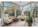 Light-filled sunroom with brick flooring, large windows, and comfortable seating at 167 Villa Di Este Ter Ter # 213, Lake Mary, FL 32746