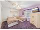 Cozy bedroom featuring two beds, a ceiling fan, and a relaxing, light purple wall paint at 1709 Palm Beach Dr, Apopka, FL 32712