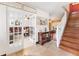 Inviting foyer with tile flooring, wooden staircase, and glass French doors leading to office space at 1709 Palm Beach Dr, Apopka, FL 32712