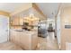 Spacious kitchen with stainless steel appliances and tile flooring, leading to a cozy living area at 1709 Palm Beach Dr, Apopka, FL 32712