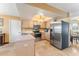 Bright kitchen features stainless steel appliances, light wood cabinets, and tile flooring at 1709 Palm Beach Dr, Apopka, FL 32712