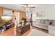Spacious living room with hardwood floors, a comfortable sofa, and a ceiling fan at 1709 Palm Beach Dr, Apopka, FL 32712