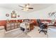 Comfortable home office featuring wainscoting, neutral decor, and an oversized ceiling fan at 1709 Palm Beach Dr, Apopka, FL 32712