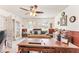 Spacious home office area with a ceiling fan, large windows, and neutral decor at 1709 Palm Beach Dr, Apopka, FL 32712