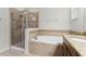 Bright bathroom with a glass shower, soaking tub, and vanity at 17158 Cypress Preserve Pkwy, Orlando, FL 32820