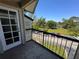 Balcony overlooking the parking lot and grassy area on a bright, sunny day at 1932 Lake Atriums Cir # 85, Orlando, FL 32839