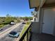 Balcony view of parking area and foliage in a condo community on a sunny day at 1932 Lake Atriums Cir # 85, Orlando, FL 32839