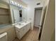 View of bathroom featuring a double sink vanity, tub with shower, and a spacious layout at 1932 Lake Atriums Cir # 85, Orlando, FL 32839