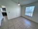 Dining area with tile floor, natural light from window, and view into the kitchen at 1932 Lake Atriums Cir # 85, Orlando, FL 32839