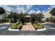 Beautifully landscaped entrance to the property with colorful shrubs and flowering trees at 1932 Lake Atriums Cir # 85, Orlando, FL 32839