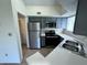 Kitchen with stainless steel appliances, white counters, and gray cabinets at 1932 Lake Atriums Cir # 85, Orlando, FL 32839
