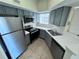 The kitchen featuring stainless steel appliances, tile floors, and bright lighting at 1932 Lake Atriums Cir # 85, Orlando, FL 32839