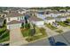 An aerial view showcases the property, well-manicured lawns, and lush trees at 2234 Bluebird Pl, St Cloud, FL 34771