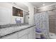 Well-lit bathroom featuring granite counters and a shower at 2234 Bluebird Pl, St Cloud, FL 34771
