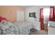 Comfortable bedroom with a large window, a double bed, and ample storage with a dresser and closet at 2234 Bluebird Pl, St Cloud, FL 34771