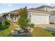 Charming single-story home with a well-maintained lawn and two-car garage, displaying great curb appeal at 2234 Bluebird Pl, St Cloud, FL 34771