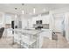 Bright kitchen features white cabinetry, stainless steel appliances, granite countertops, and a breakfast bar area at 2234 Bluebird Pl, St Cloud, FL 34771