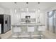 Modern kitchen with an island and stainless steel appliances, illuminated by stylish pendant lights at 2234 Bluebird Pl, St Cloud, FL 34771