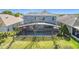 Expansive backyard featuring a screened-in pool and lush green lawn, perfect for outdoor enjoyment at 2263 Mallard Creek Cir, Kissimmee, FL 34743