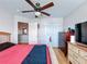 Comfortable bedroom featuring laminate floors, a ceiling fan, and a closet at 2263 Mallard Creek Cir, Kissimmee, FL 34743