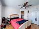 Bedroom with laminate flooring, ceiling fan, closet, and natural lighting at 2263 Mallard Creek Cir, Kissimmee, FL 34743