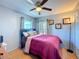 Bedroom with a beautiful window with light blue colored walls and hardwood floors at 2263 Mallard Creek Cir, Kissimmee, FL 34743
