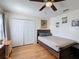 This bedroom features a large closet, neutral colors, and hardwood floors at 2263 Mallard Creek Cir, Kissimmee, FL 34743