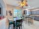 Breakfast nook with glass table and chairs next to the kitchen with views of backyard at 2263 Mallard Creek Cir, Kissimmee, FL 34743