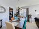 Dining room featuring decorative chandelier lighting and seating for six people at 2263 Mallard Creek Cir, Kissimmee, FL 34743