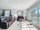 Bright living room features neutral walls, tile flooring and a large window for ample sunlight at 2263 Mallard Creek Cir, Kissimmee, FL 34743