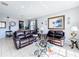 Bright living room features neutral walls, tile flooring, and comfortable leather seating at 2263 Mallard Creek Cir, Kissimmee, FL 34743