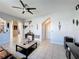 This living room has tile flooring, ceiling fan and flows into the kitchen and eating nook at 2263 Mallard Creek Cir, Kissimmee, FL 34743