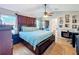 Spacious bedroom with a ceiling fan, fireplace, and hardwood floors at 2263 Mallard Creek Cir, Kissimmee, FL 34743