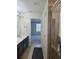 Bathroom featuring a double sink vanity, glass-enclosed shower, and tile flooring at 2355 Seven Oaks Dr, St Cloud, FL 34772