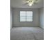 Spacious bedroom featuring neutral carpet, a ceiling fan, and a bright window at 2355 Seven Oaks Dr, St Cloud, FL 34772