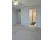 Spacious bedroom with neutral carpet leading to the bathroom at 2355 Seven Oaks Dr, St Cloud, FL 34772