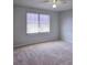 Bedroom with neutral carpet, ceiling fan, and a bright window at 2355 Seven Oaks Dr, St Cloud, FL 34772