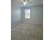 Bedroom with neutral carpet, ceiling fan, and a bright window at 2355 Seven Oaks Dr, St Cloud, FL 34772