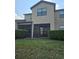 Back exterior view featuring an enclosed patio and well-kept lawn at 2355 Seven Oaks Dr, St Cloud, FL 34772