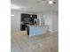 Open-concept kitchen with island, dark cabinets, and stainless steel appliances, ideal for entertaining at 2355 Seven Oaks Dr, St Cloud, FL 34772