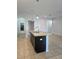Open kitchen boasts island with granite countertop and stainless steel sink, complemented by pendant lighting at 2355 Seven Oaks Dr, St Cloud, FL 34772