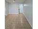 Spacious living room with tile flooring and neutral walls, leading to the entryway door at 2355 Seven Oaks Dr, St Cloud, FL 34772