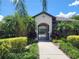 Gated entrance to the community pool, surrounded by lush tropical landscaping on a bright day at 2355 Seven Oaks Dr, St Cloud, FL 34772