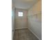 Walk-in closet featuring neutral carpet, a bright window, and closet racks at 2355 Seven Oaks Dr, St Cloud, FL 34772