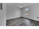 A modern bedroom featuring hardwood flooring, natural lighting from arch window, and crisp white walls at 23940 Oak Ln, Sorrento, FL 32776